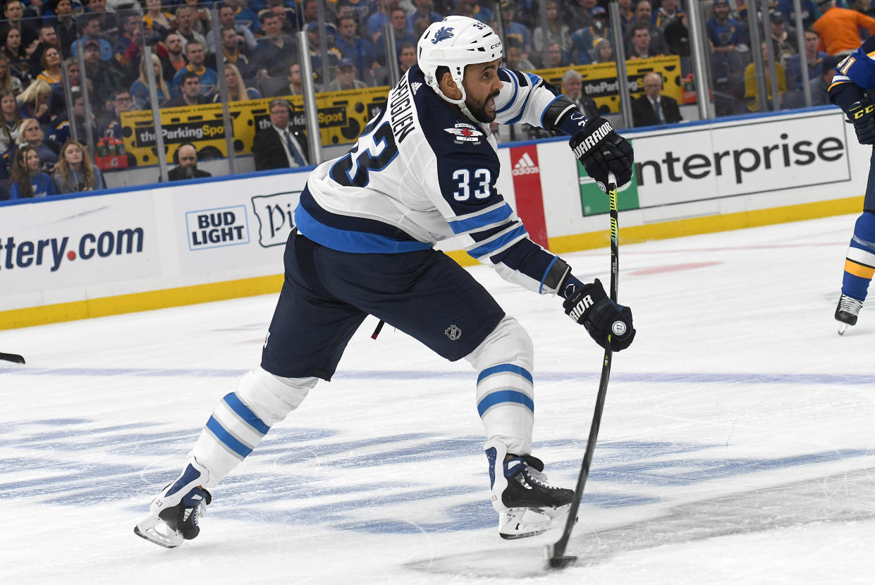 ST. LOUIS, MO - APRIL 16: Winnipeg Jets defenseman Dustin Byfuglien (33) passes the puck during a first round Stanley Cup Playoffs game between the Winnipeg Jets and the St. Louis Blues, on April 16, 2019, at Enterprise Center, St. Louis, Mo. (Photo by Keith Gillett/Icon Sportswire via Getty Images)