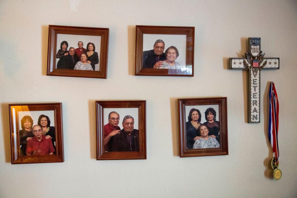Photos of Simon Mendoza, a World War II veteran, and his family hang on the wall on Wednesday, Oct. 26, 2022, in his home in Doña Ana. Mendoza will be turning 100 years old on Friday, Oct. 28.
