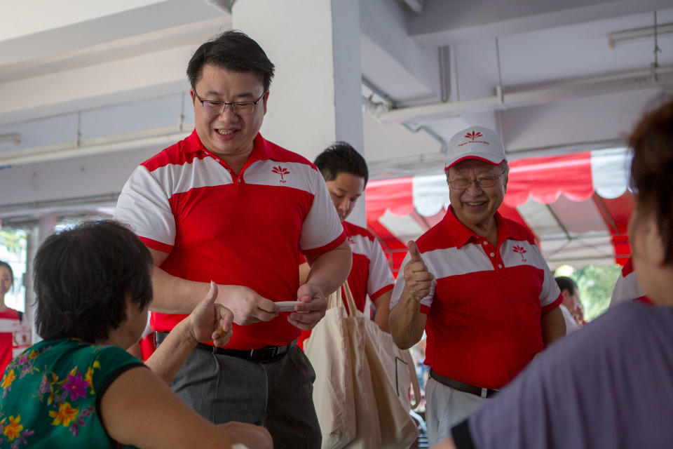 Anthony Lee, the PSP's assistant secretary-general, and PSP secretary-general Tan Cheng Bock greeting a Ghim Moh resident. (PHOTO: Dhany Osman / Yahoo News Singapore)