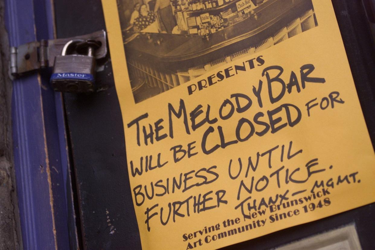 A sign hangs on the padlocked front door of the Melody Bar on March 22, 2001.