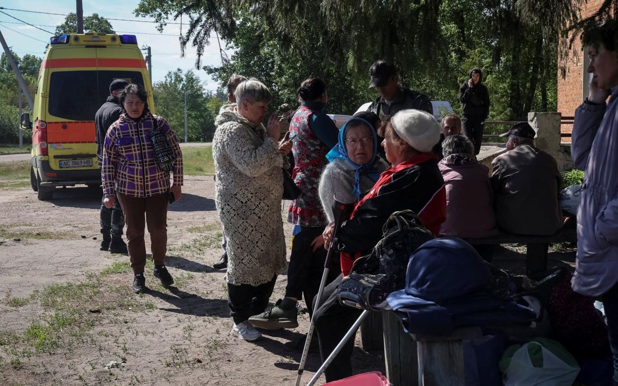 Residents from Vovchansk and nearby villages wait for buses amid evacuation