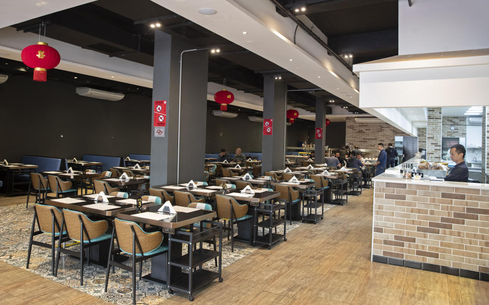 A Chinese restaurant is almost empty during lunch hour in the Asian neighborhood of Liberdade in Sao Paulo, Brazil, Thursday, Feb. 27, 2020. According to the restaurant manager, fears of new coronavirus COVID-19 outbreak have reduced business over the past weeks. (AP Photo/Andre Penner)