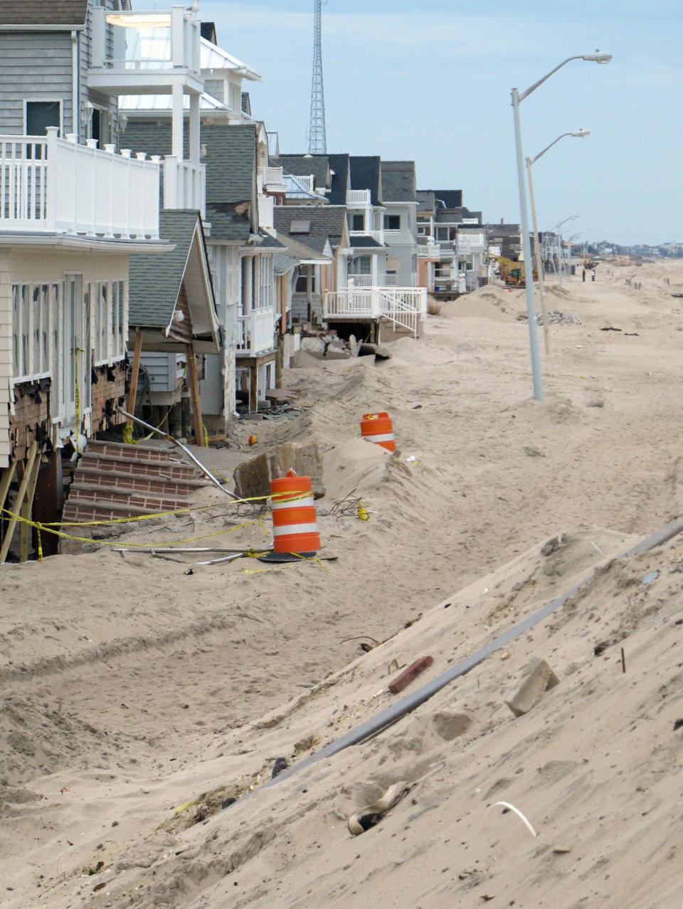This Jan. 9, 2013 photo shows the beach walk in Manasquan N.J. buried under tons of sand seven weeks after Superstorm Sandy. The town decided not to rebuild its dunes following Sandy, but the U.S. Army Corps of Engineers will review whether the handful of places along the New Jersey shore that don't have dunes now should build them. (AP Photo/Wayne Parry)