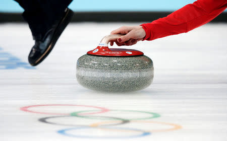FILE PHOTO: Britain's skip Eve Muirhead delivers a stone during their women's curling bronze medal game at the 2014 Sochi Winter Olympics in the Ice Cube Curling Centre in Sochi February 20, 2014. REUTERS/Phil Noble/File photo