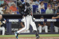 Miami Marlins' Bryan De La Cruz hits a double during the first inning of a baseball game against the Philadelphia Phillies, Friday, May 10, 2024, in Miami. (AP Photo/Wilfredo Lee)