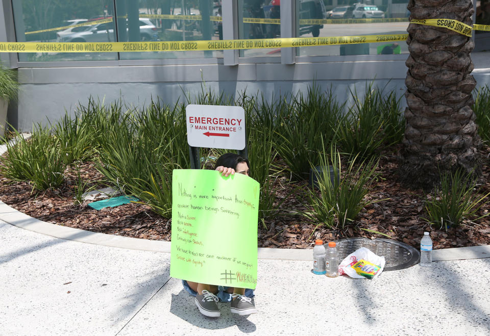 <p>People hold a vigil outside the Orlando Regional Medical Center in the aftermath of a mass shooting in Orlando, Florida, on June 12, 2016. (GREGG NEWTON/AFP/Getty Images) </p>