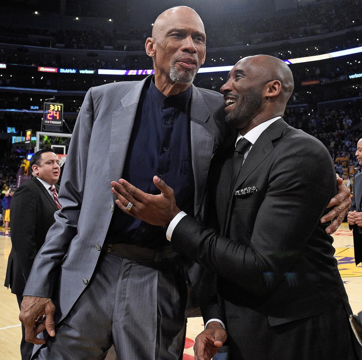 Kobe Bryant and Kareem Abdul-Jabbar shshare a moment at halftime after both of Bryant's #8 and #24 Los Angeles Lakers jerseys are retired at Staples Center on December 18, 2017 in Los Angeles, California.