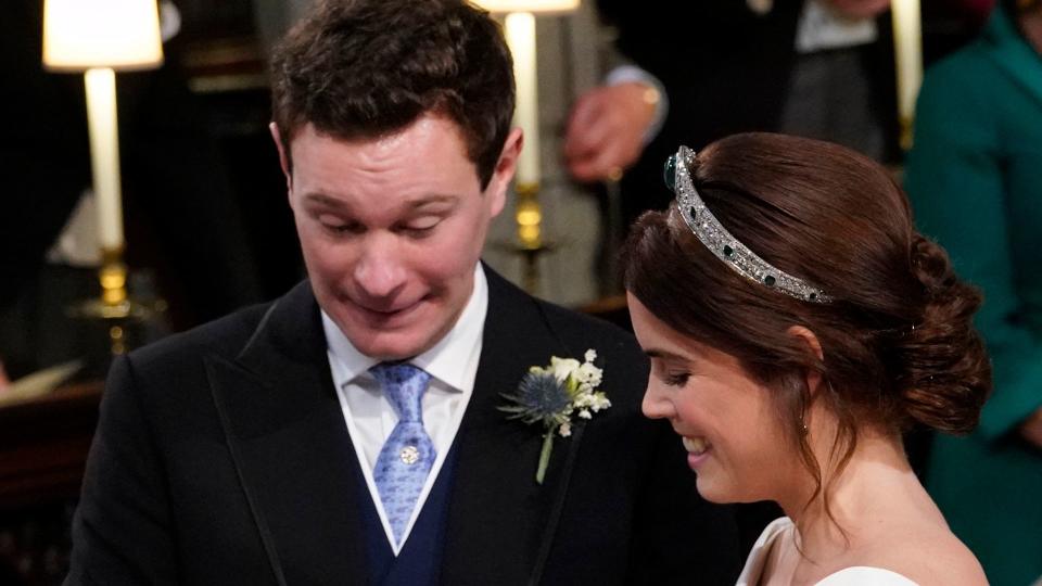 Princess Eugenie smiles as Jack Brooksbank put the ring on her finger during their wedding ceremony