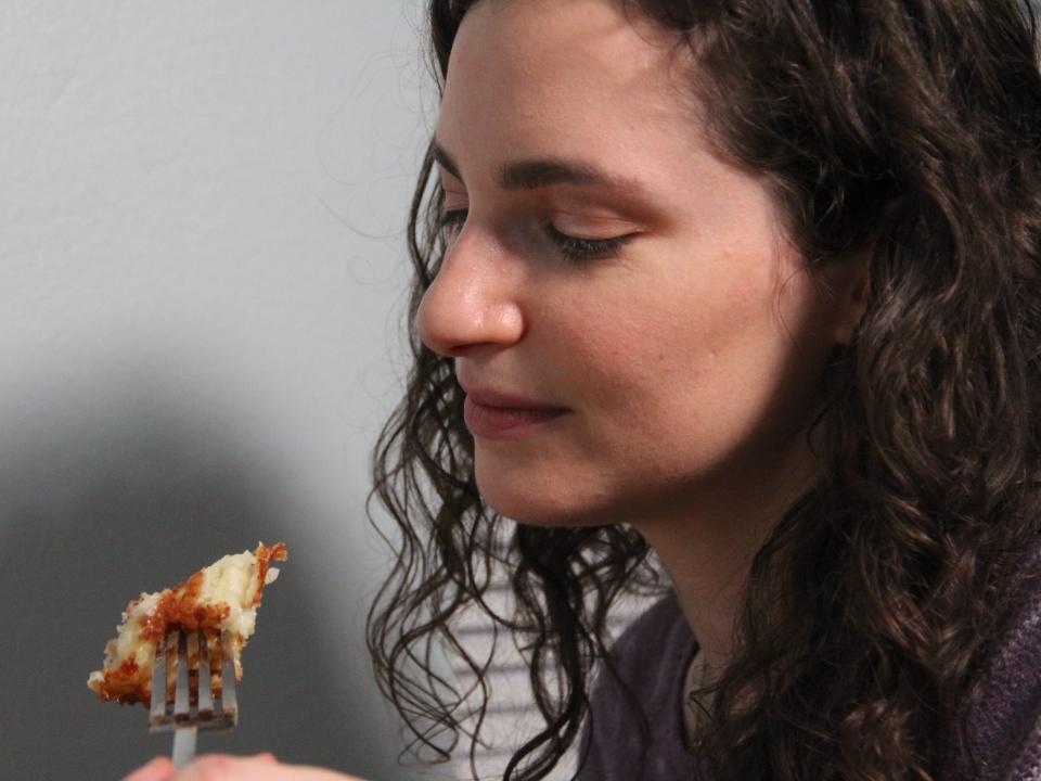 A woman eating latkes.