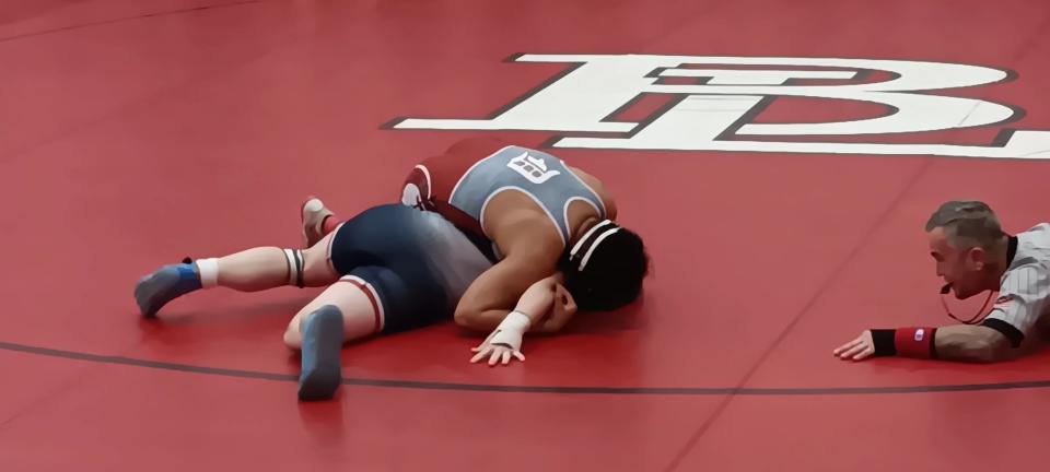 Dover's Adolfo Lopez, top, prepares to pin Austintown Fitch's Liam Yanvari as the official, right, looks on during their 165-pound match at Saturday's 46th annual Everett Hoppel Memorial Wrestling Tournament at Beaver Local High School. Lopez placed fourth in the tourney.