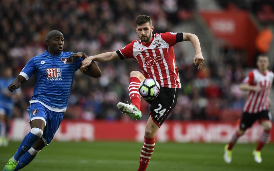 <p>Bournemouth’s Benik Afobe in action with Southampton’s Jack Stephens </p>