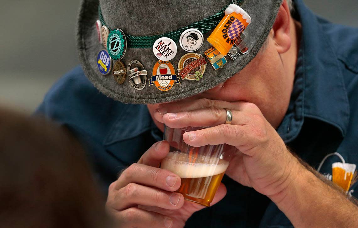 Mike Walters of St. Louis Brews judges the aroma of a light ale during the Happy Holidays Home-brew Competition in 2020. Judges work in two-person teams, evaluating the best in aroma, appearance, flavor and the defined weight or thickness of the beer.