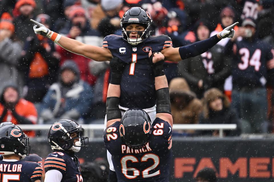 Chicago Bears quarterback Justin Fields (1) celebrates with offensive lineman Lucas Patrick (62) after running for a 9-yard touchdown in the first half against the Atlanta Falcons at Soldier Field.