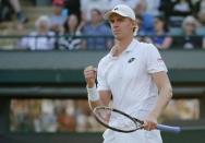 Kevin Anderson of South Africa celebrates after winning the first set of his match against Novak Djokovic of Serbia at the Wimbledon Tennis Championships in London, July 6, 2015. REUTERS/Suzanne Plunkett