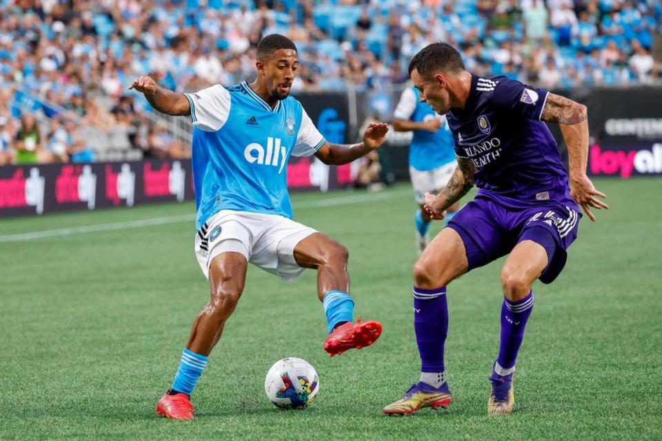 Charlotte FC midfielder McKinze Gaines, left, controls the ball against Orlando City defender Kyle Smith (24) in the first half in Charlotte, N.C., Sunday, Aug. 21, 2022.