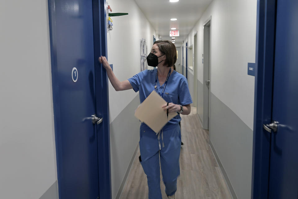 Dr. Elizabeth Brett Daily enters an exam room consult with a patient about the medical abortion process at a Planned Parenthood clinic Wednesday, Oct. 12, 2022, in Kansas City, Kan. (AP Photo/Charlie Riedel)