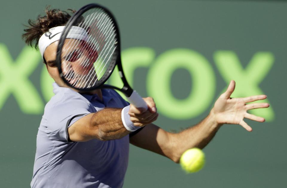 Roger Federer, of Switzerland, returns the ball to Richard Gasquet, of France, during the Sony Open tennis tournament, Tuesday, March 25, 2014, in Key Biscayne, Fla. (AP Photo/Luis M. Alvarez)