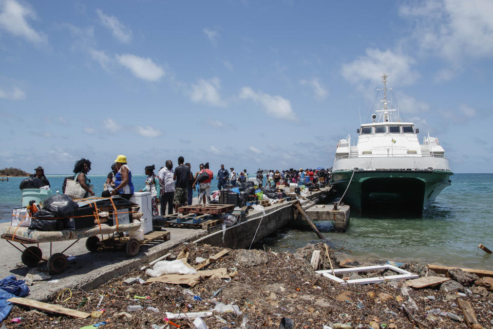 People whose homes were destroyed by Hurricane Beryl wait to be evacuated from Clifton, Union Island, St. Vincent and the Grenadines, Thursday, July 4, 2024. (AP Photo/Lucanus Ollivierre)