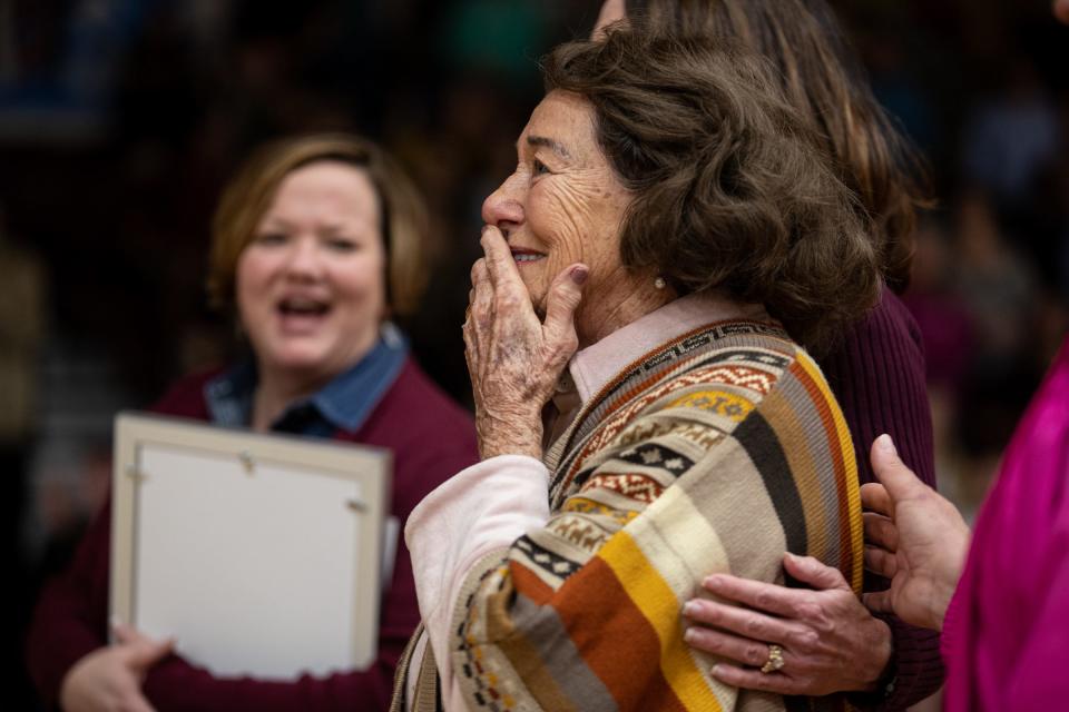 Former Calallen girls basketball coach Leta Andrews watches old video clips from when she was a coach during a gym dedication ceremony honoring her at Calallen High School on Friday, Jan. 13, 2023, in Corpus Christi, Texas. 