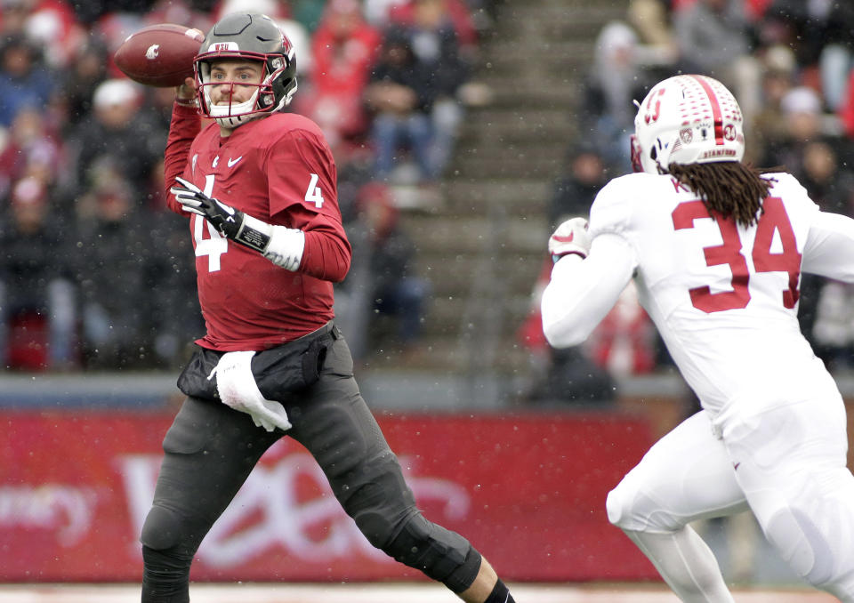 Washington State quarterback Luke Falk (4) throws a pass as he is chased by Stanford linebacker Peter Kalambayi (34) during the first half of an NCAA college football game in Pullman, Wash., Saturday, Nov. 4, 2017. (AP Photo/Young Kwak)