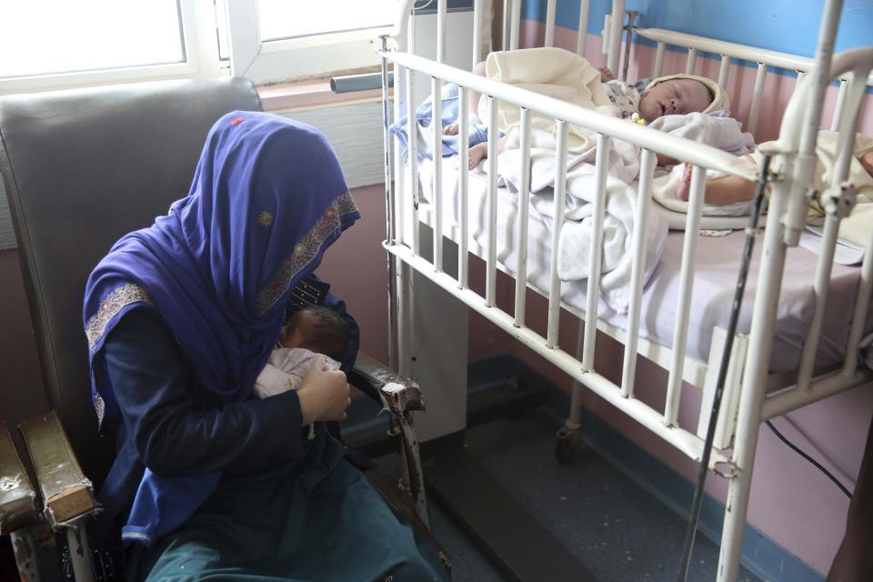 A mother breastfeeds her two-day-old baby at the Ataturk Children's Hospital a day after being rescued from another maternity hospital following a deadly attack, in Kabul, Afghanistan, Wednesday, May 13, 2020. Militants stormed the Barchi National Maternity Hospital in the western part of Kabul on Tuesday, setting off an hours-long shootout with the police and killing tens of people, including two newborn babies, their mothers and an unspecified number of nurses, Afghan officials said. (AP Photo/Rahmat Gul)