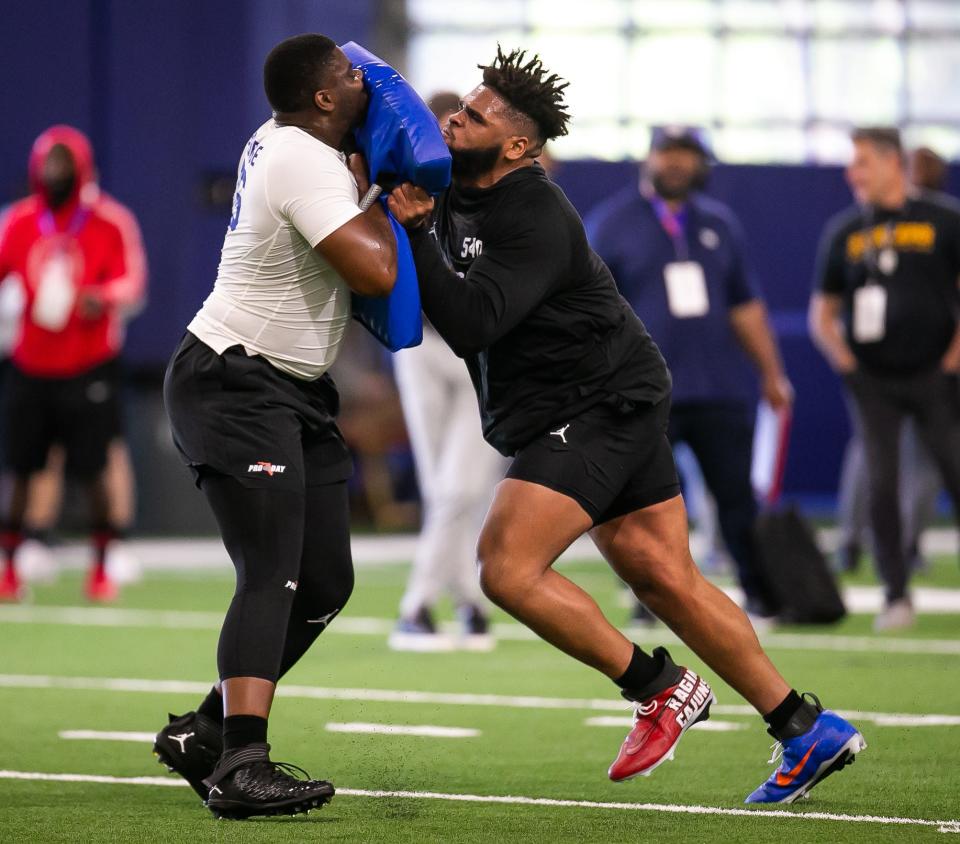 Florida Gators offensive lineman O'Cyrus Torrence (54), left, runs a blocking drill with Florida Gators offensive lineman Richard Gouraige (76) during the 2023 NFL Pro Day held at Condron Family Indoor Practice Facility in Gainesville, FL on Thursday, March 30, 2023. [Doug Engle/Gainesville Sun]