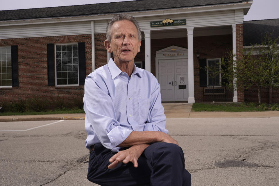 Elm Grove Village President Neil Palmer poses for a picture outside the village hall on April 27, 2021, in Elm Grove, Wis. At the 100-day mile marker, polls show most Americans are giving Biden positive marks for his early performance, particularly for his management of coronavirus pandemic. But in one pocket of swing-state Wisconsin, where a suburban surge helped put Biden in the White House, interviews with voters show that support often falls short of adulation (AP Photo/\Morry Gash)