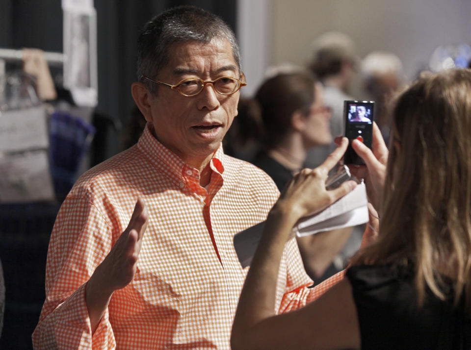 Designer Tadashi Shoji is interviewed backstage before his Spring 2013 collection is modeled, during Fashion Week in New York, Thursday, Sept. 6, 2012. (AP Photo/Richard Drew)