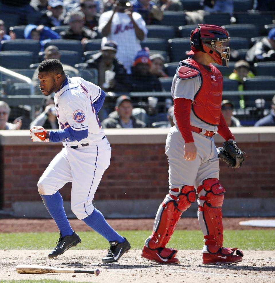 New York Mets Eric Young Jr. (22) scores on Daniel Murphy's sixth-inning, RBI double in a baseball game against the St. Louis Cardinals in New York, Thursday, April 24, 2014. Cardinals catcher Tony Cruz is at right. (AP Photo/Kathy Willens)