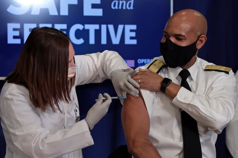 U.S. Surgeon General Jerome Adams receives the COVID-19 vaccine at the White House in Washington