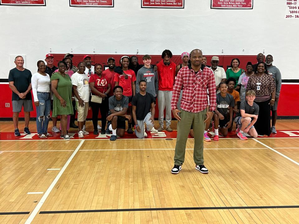 James Dawson (front) takes photos with his players, parents and supporters after being introduced as Vero Beach High School’s new head boys basketball coach on Tuesday, March 26, 2024 from John B. Witt Gym.