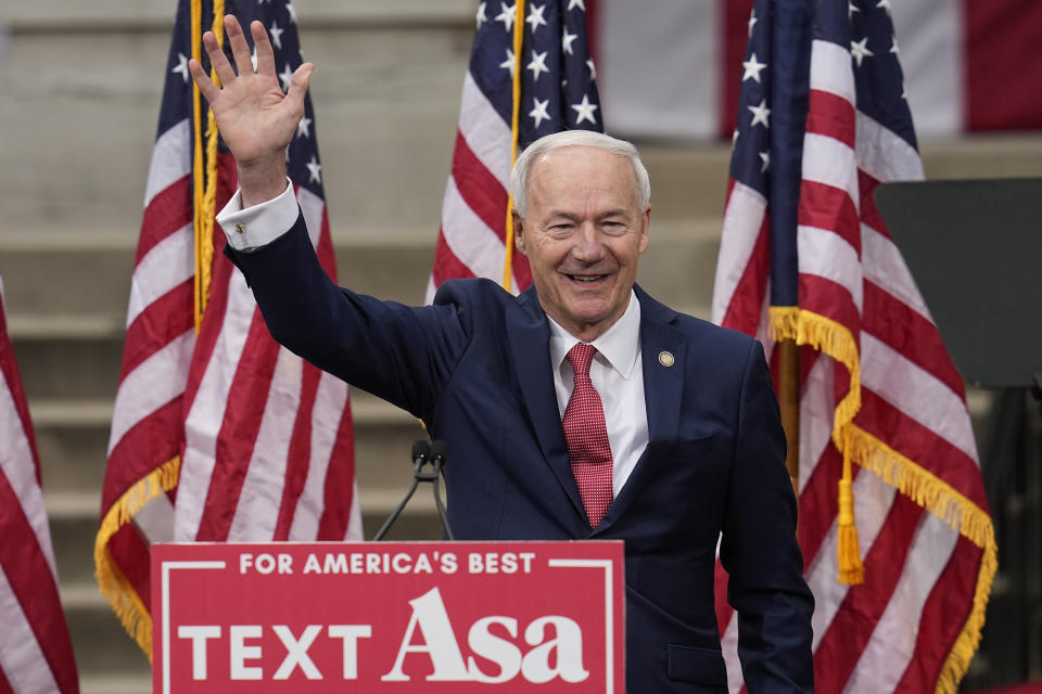 Former Arkansas Gov. Asa Hutchinson waves after formally announcing his Republican campaign for president, Wednesday, April 26, 2023, in Bentonville, Ark. (AP Photo/Sue Ogrocki)