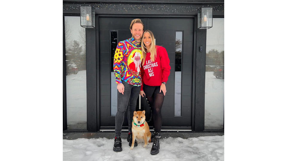 Olly and Amelia in snow outside black house