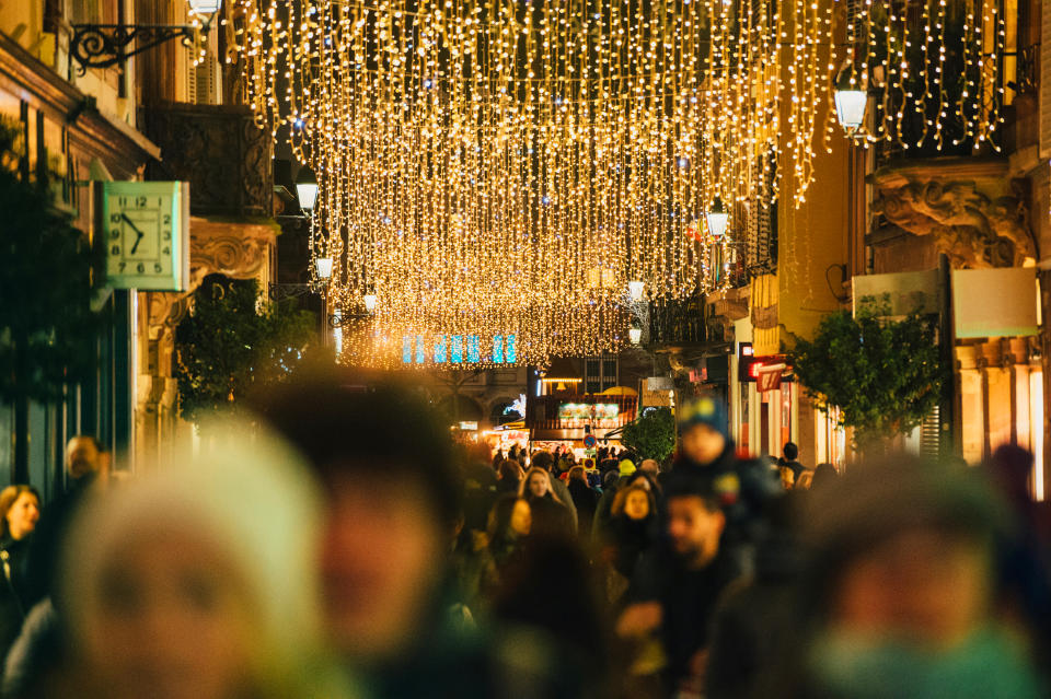 Crowd on busy Christmas-illuminated street