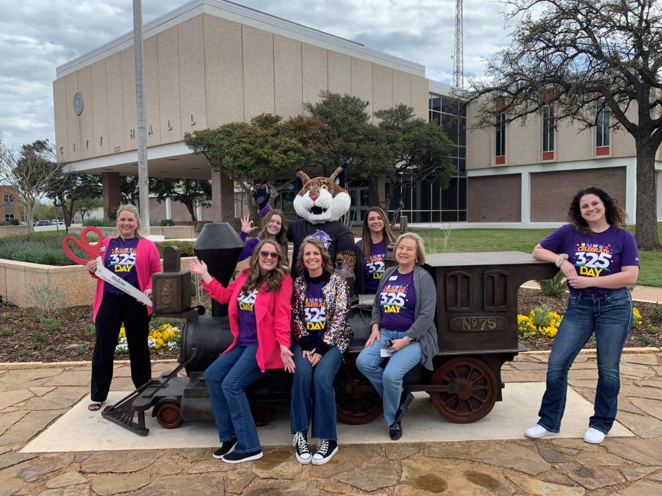 The 325 Day Ambassadors celebrate the start of 325 Day outside City Hall on Monday with the Abilene Chamber of Commerce and Willie the Wildcat from Abilene Christian University.