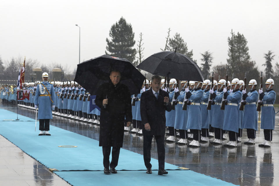 Turkish President Recep Tayyip Erdogan, left, and Finland's President Sauli Niinisto inspect a military honor guard during a welcome ceremony at the presidential palace in Ankara, Turkey, Friday, March 17, 2023. Erdogan greeted his Finnish counterpart in Ankara on Friday amid hopes that their meeting will see Turkey approve Finland's NATO membership bid. (AP Photo/Burhan Ozbilici)