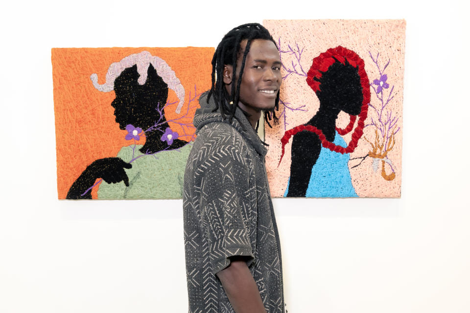 Mali artist Alassane Kone with two of his textile works.