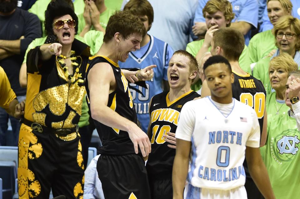 Hawkeye Elvis points and screams excitedly as Iowa's Mike Gesell celebrates with Adam Woodbury and Jarrod Uthoff late in a matchup against North Carolina in Chapel Hill, North Carolina on Dec. 3, 2014.