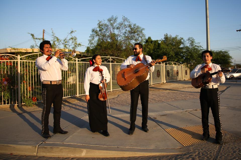 Mariachi Nuevo Amanecer performs while walking through a neighborhood in Mecca, Calif. to spread joy to those at home during the coronavirus pandemic on Sunday, May 17, 2020.