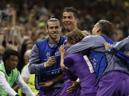 Britain Soccer Football - Juventus v Real Madrid - UEFA Champions League Final - The National Stadium of Wales, Cardiff - June 3, 2017 Real Madrid's Cristiano Ronaldo celebrates scoring their third goal with Gareth Bale and teammates Reuters / Carl Recine Livepic