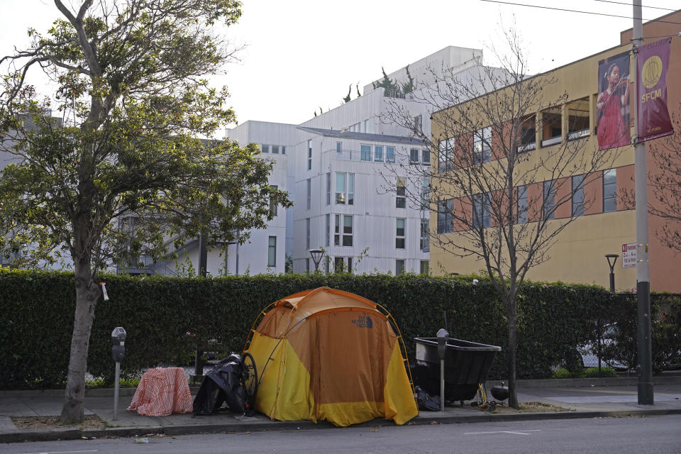 A tent is seen on a sidewalk just around the corner from the Opera House with a residential building in the background in San Francisco, Thursday, Dec. 2, 2021. In San Francisco, homeless tents, open drug use, home break-ins and dirty streets have proliferated during the pandemic. The quality of life crimes and a laissez-faire approach by officials to brazen drug dealing have given residents a sense the city is in decline. (AP Photo/Eric Risberg)