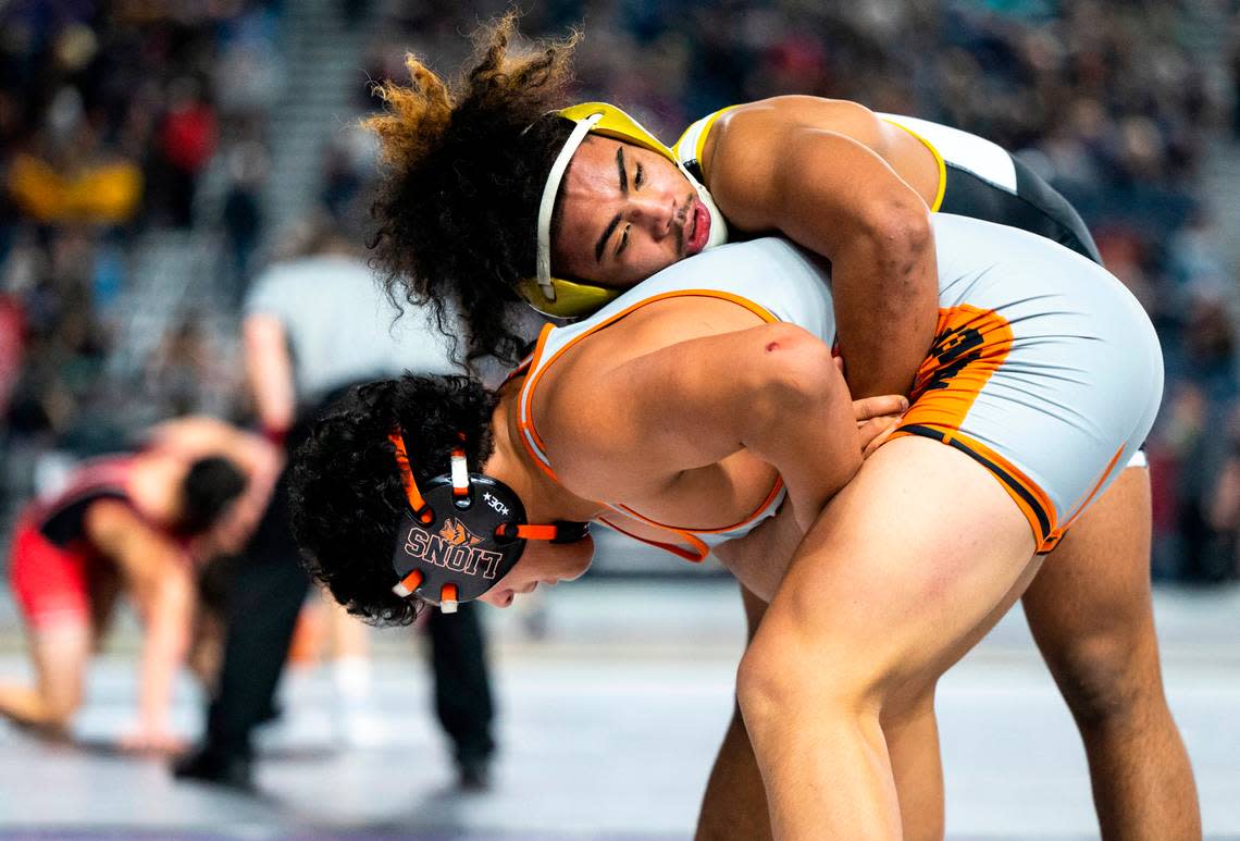 Lincoln Navarre Dixon holds Kennewick Jaden Lopez from behind during the 182-pound 3A quarterfinal match at Mat Classic XXXIV on Friday, Feb. 17, 2023, at the Tacoma Dome in Tacoma, Wash. Dixon defeated Lopez 14-6.