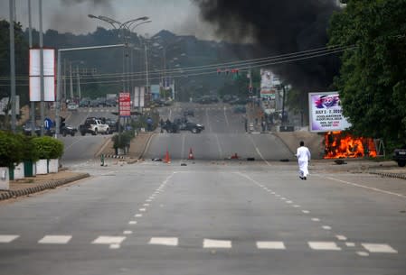 A member of the Shi'ite movement lies dead after the Shi'ite group set an ambulance and a fire engine on fire at the Federal Secretariat in Abuja