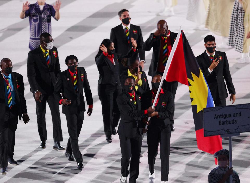 The athletes wore dark suits with ties and shirts that match the colors of their flag