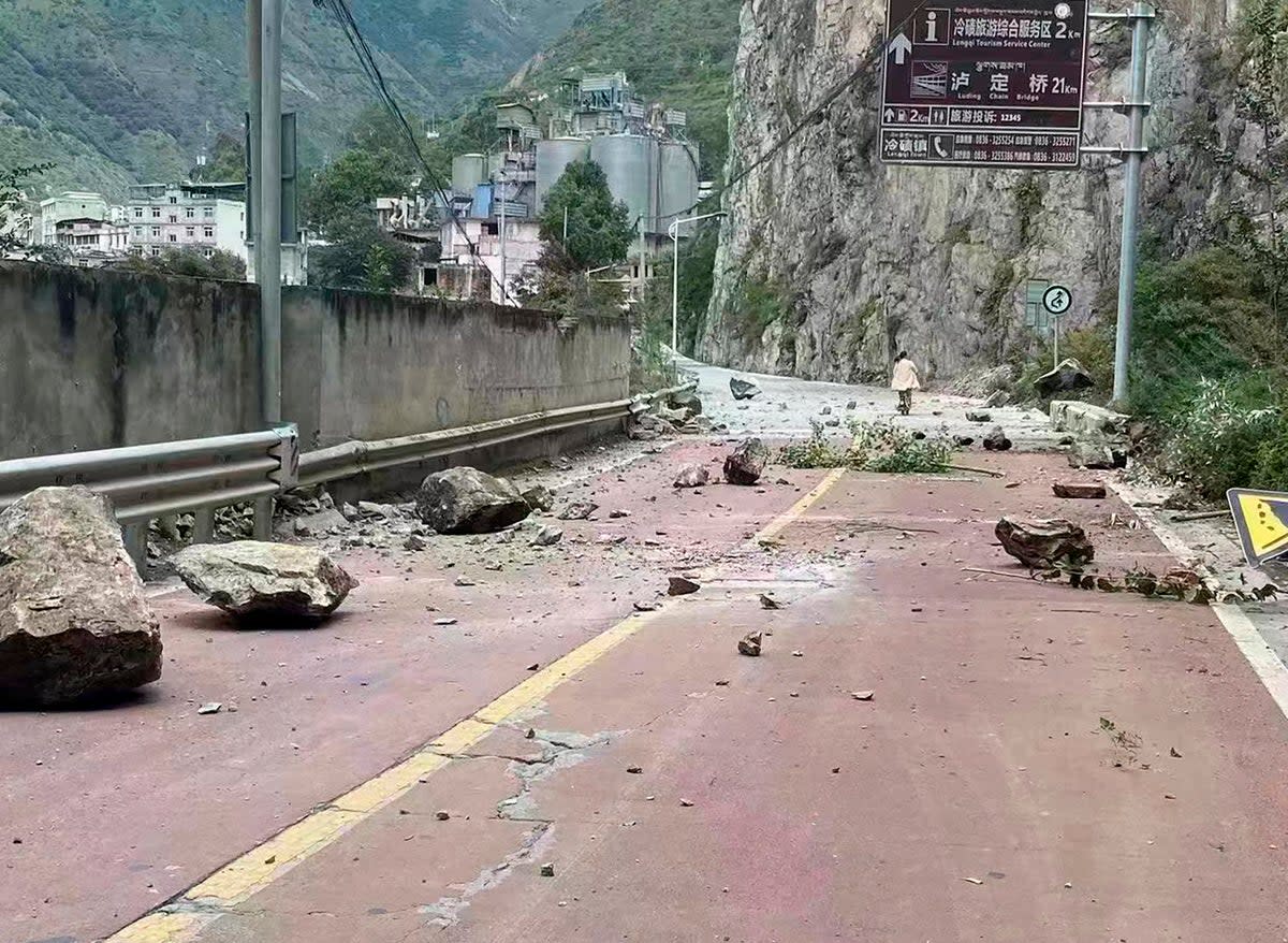 Fallen rocks are seen on a road near Lengqi Town in Luding County, Sichuan after a strong earthquake on 5 September (AP)