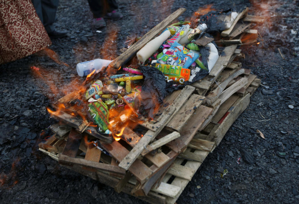 Offerings burn in honor of the "Pachamama," or Mother Earth, on La Cumbre mountain considered sacred by Bolivia's indigenous on the outskirts of La Paz, Bolivia, Thursday, Aug. 1, 2013. During the month of August, people gather on sacred mountains to make offerings and ask for wealth to Mother Earth. According to local agrarian tradition, Mother Earth awakes hungry and thirsty in August and needs offerings of food and drink in order for her to be fertile and yield abundant crops. (AP Photo/Juan Karita)