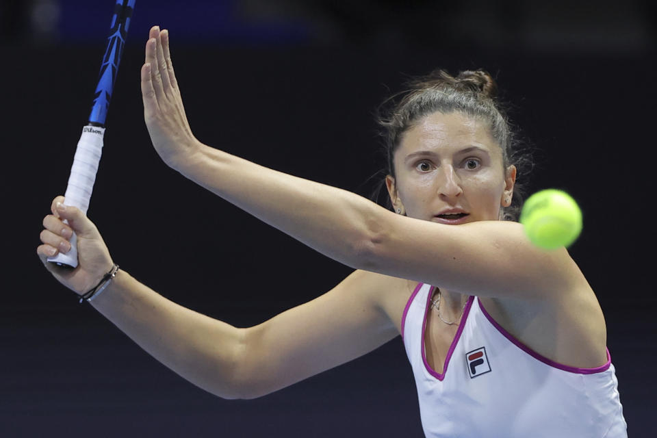 FILE - Irina-Camelia Begu of Romania returns the ball to Maria Sakkari of Greece during the St. Petersburg Ladies Trophy tennis tournament semi-final match in St.Petersburg, Russia, Saturday, Feb. 12, 2022. at the French Open was allowed to continue her match -- and ended up winning it -- after she threw her racket and it bounced into the stands, the latest in a series of episodes involving professional tennis players who take their anger out on their equipment. (AP Photo/Elena Ignatyeva, File)