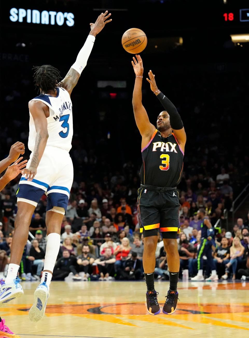 Nov 1, 2022; Phoenix, AZ, USA; Phoenix Suns guard Chris Paul (3) shoots a jumper over Minnesota Timberwolves forward Jaden McDaniels (3) in the first half at Footprint Center.