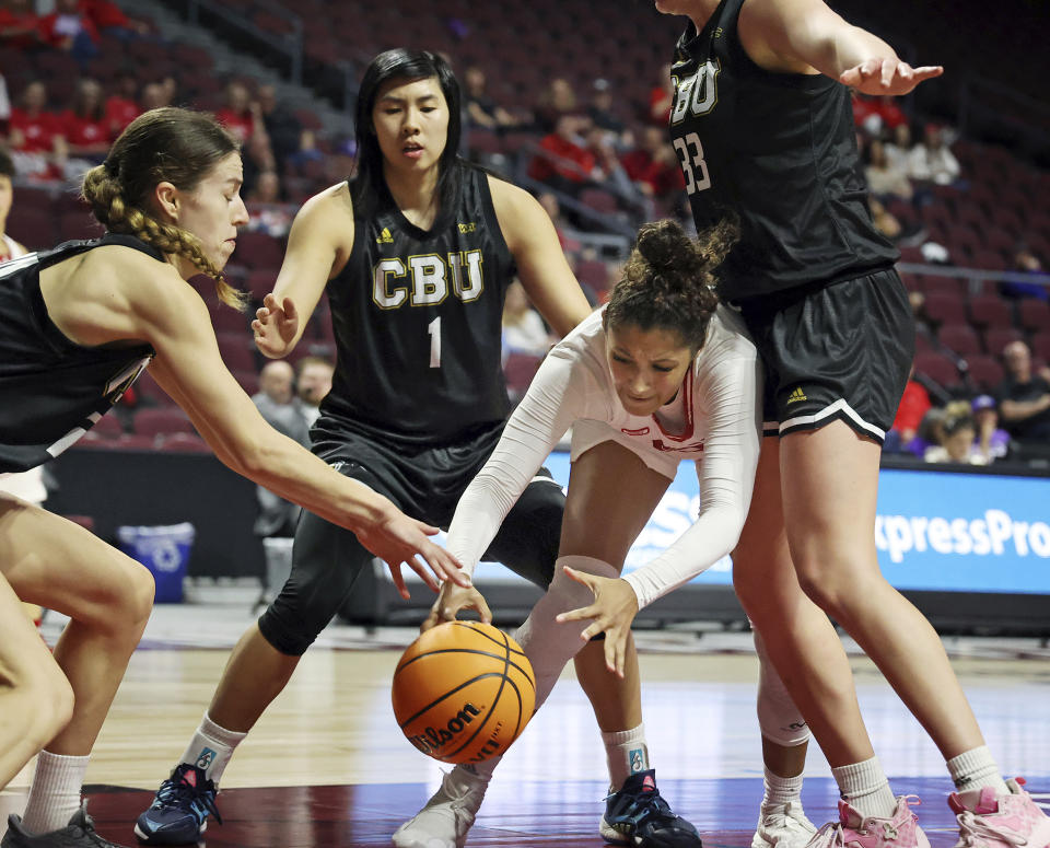 Southern Utah guard Tomekia Whitman, third from left, and California Baptist guard Brittany Klaman, left, go for a loose ball during the first half of an NCAA college basketball game in the championship of the Western Athletic Conference tournament, Saturday, March 11, 2023, in Las Vegas. (AP Photo/Ronda Churchill)