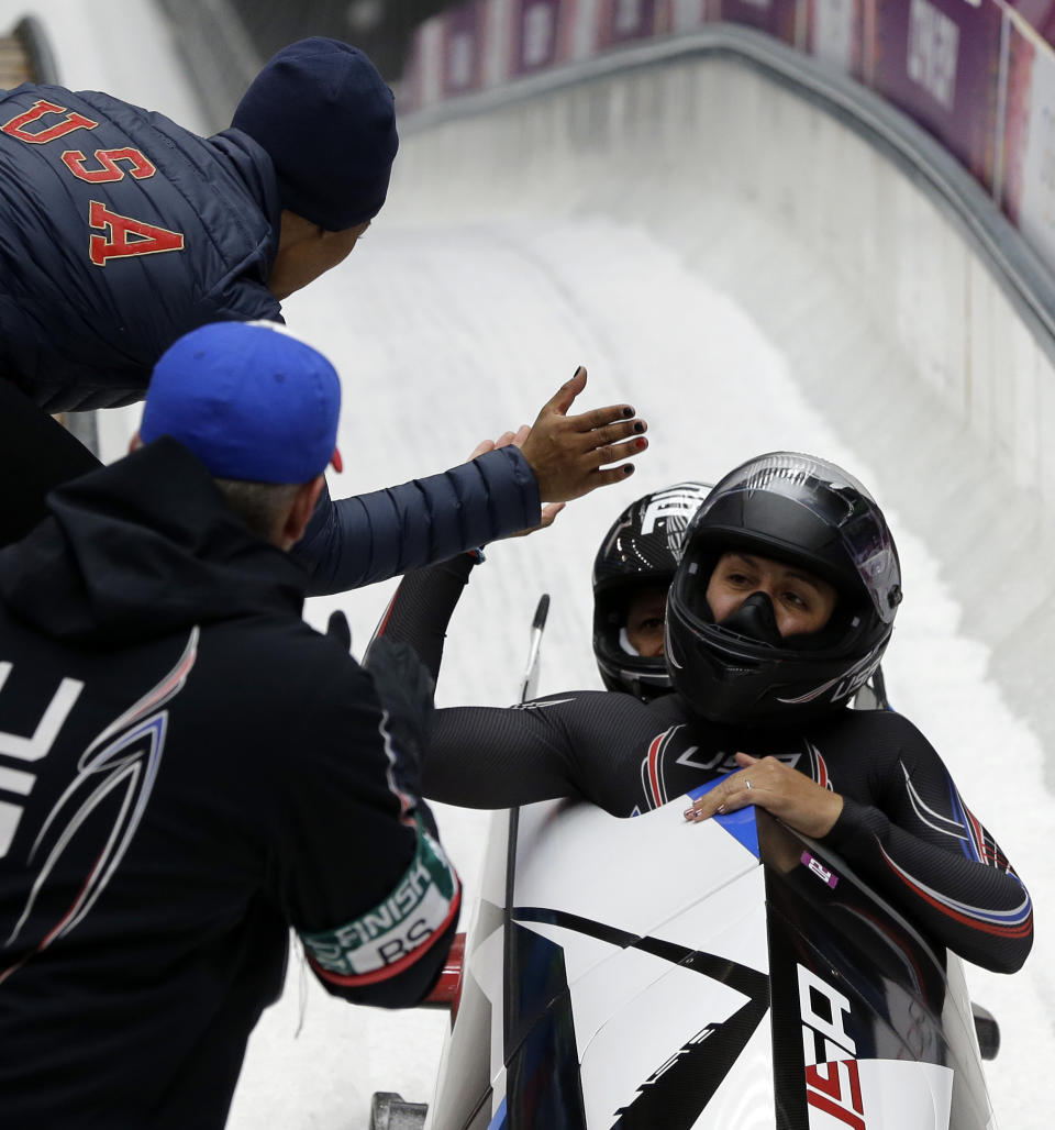 The team from the United States USA-1, piloted by Elana Meyers with brakeman Lauryn Williams, cross into the finish area to win the silver medal during the women's bobsled competition at the 2014 Winter Olympics, Wednesday, Feb. 19, 2014, in Krasnaya Polyana, Russia. (AP Photo/Michael Sohn)